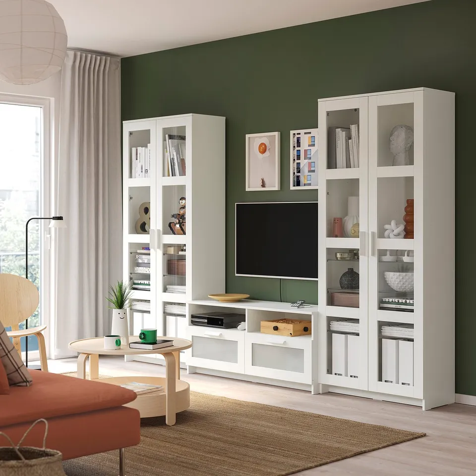 Modern living room with BRIMNES cabinets and tv bench. Bright green walls, orange sofa, and light floors.