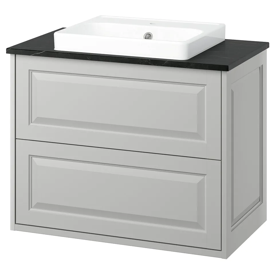Elegant white bathroom vanity with two drawers, sleek black countertop and square sink. Minimalist and modern design.