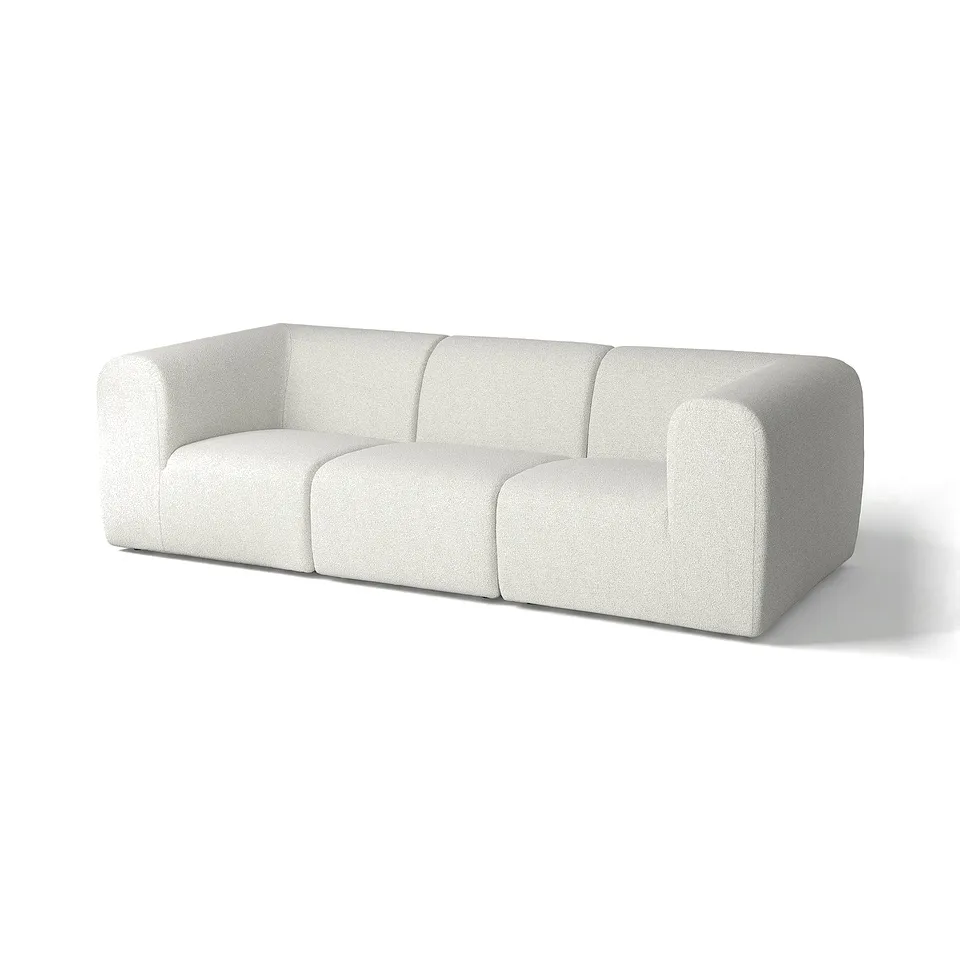 Modern white sofa with rounded edges, plush fabric, and geometric design.
