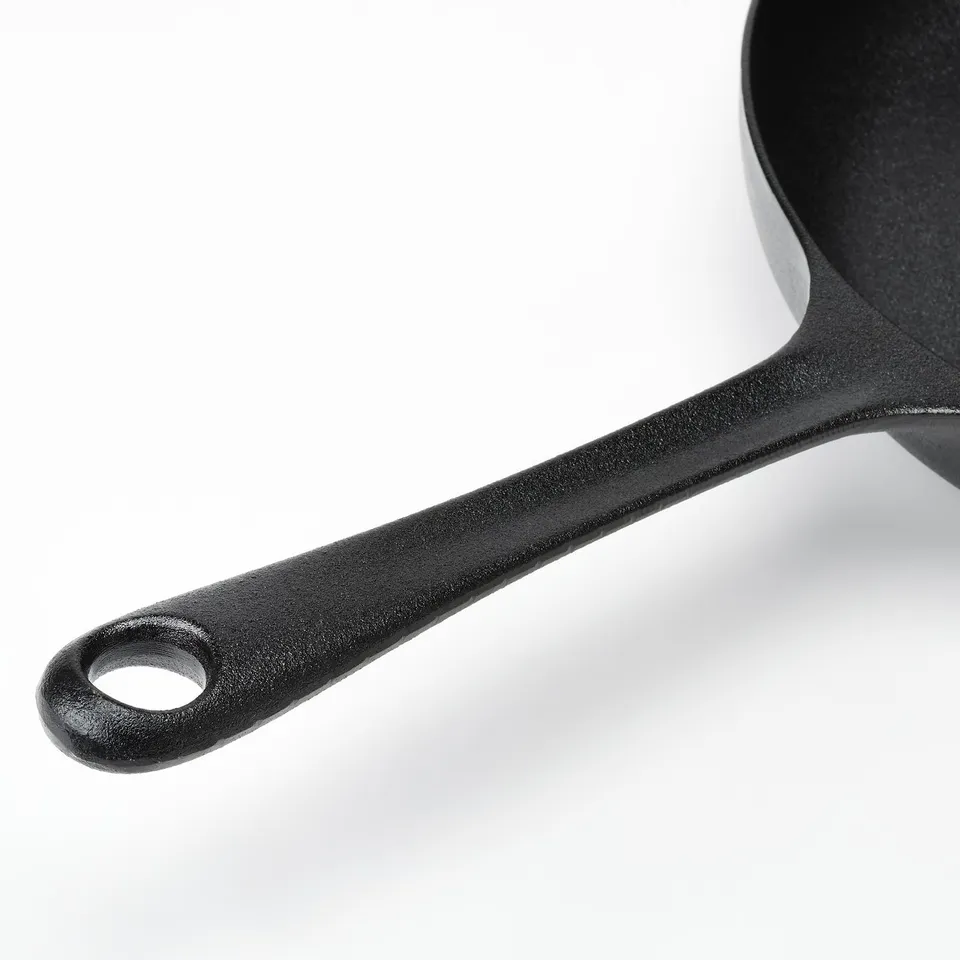 Black cast iron frying pan handle, robust and sturdy, designed for secure grip.