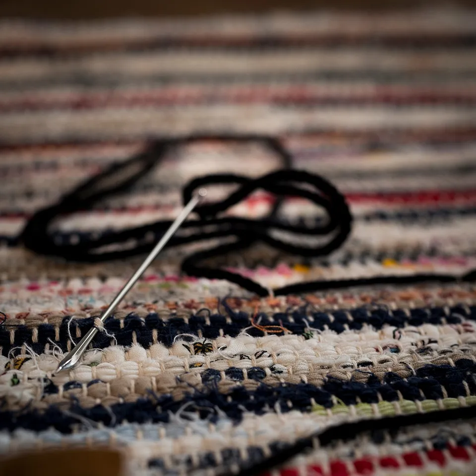 Colourful TÅNUM rug detail: black yarn, blue-white weave, handmade.