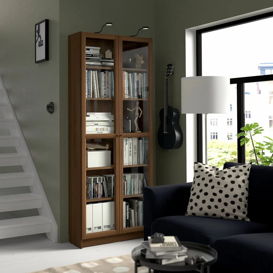 Modern living room with BILLY bookcase, city view, and guitar.
