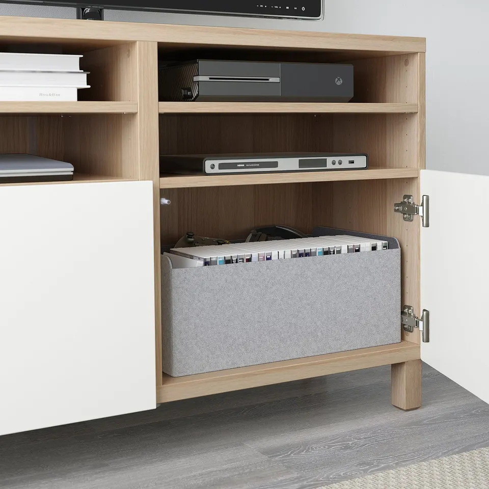 Light wood tv stand with hidden cable storage, soft-close doors, and adjustable shelves.