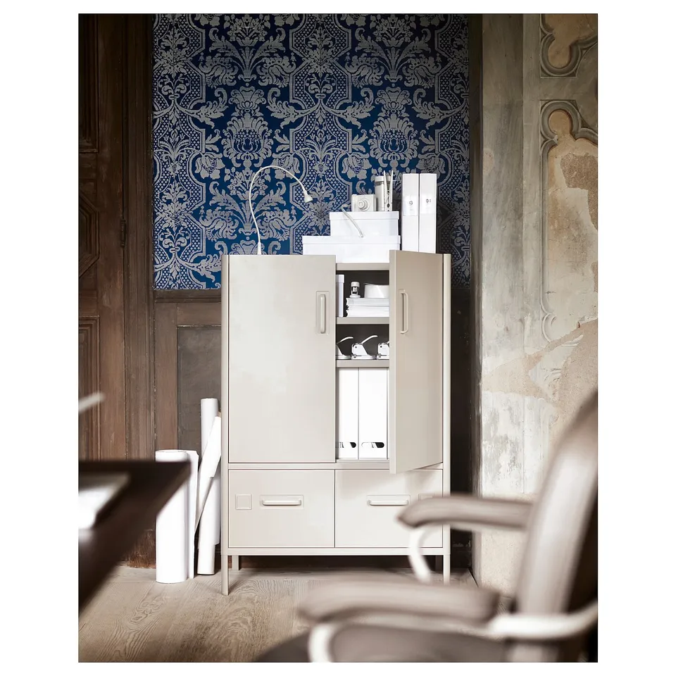 Modern IDÅSEN cabinet, cream-colored, metal & wood, rectangular, with adjustable shelves, in stylish room.