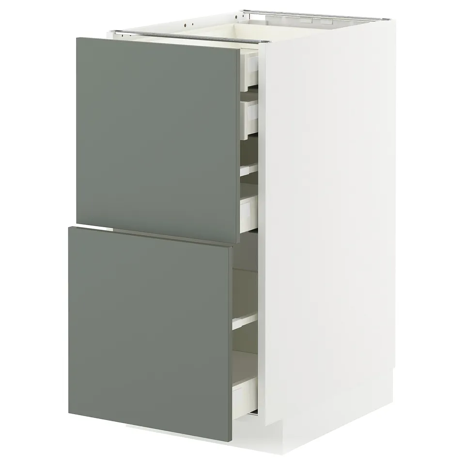 Modern kitchen cabinet with grey-green drawers and white frame.