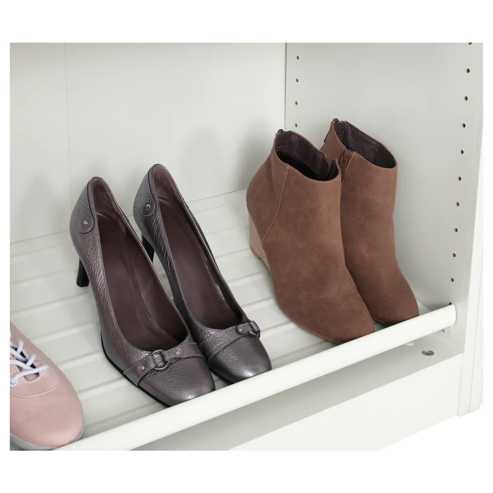 White shelf holding black heels and brown boots, displayed neatly for easy access.
