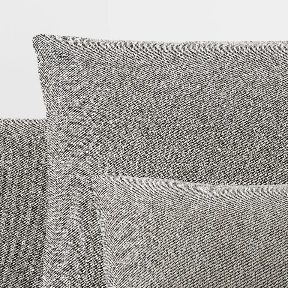 Modern sofa corner with plush, textured grey upholstery, offering comfort and style.