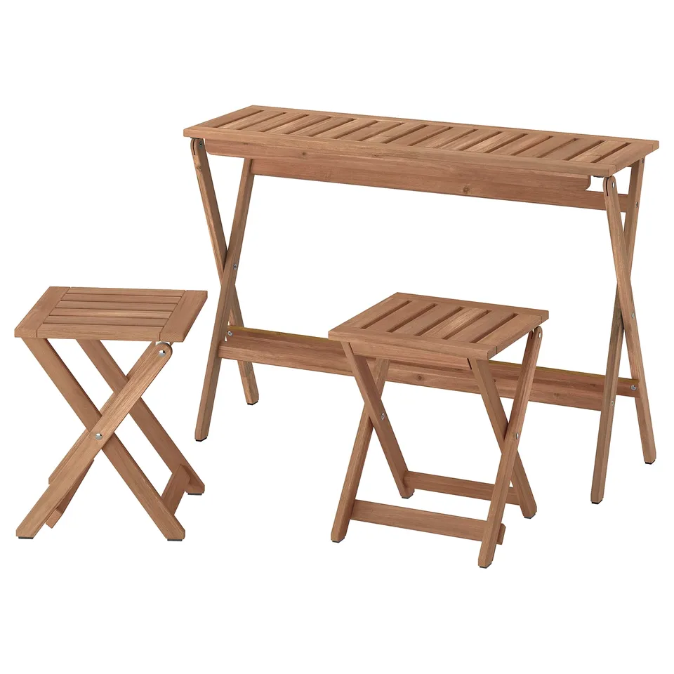 A NÄMMARÖ acacia wood outdoor table and chairs, foldable and portable.