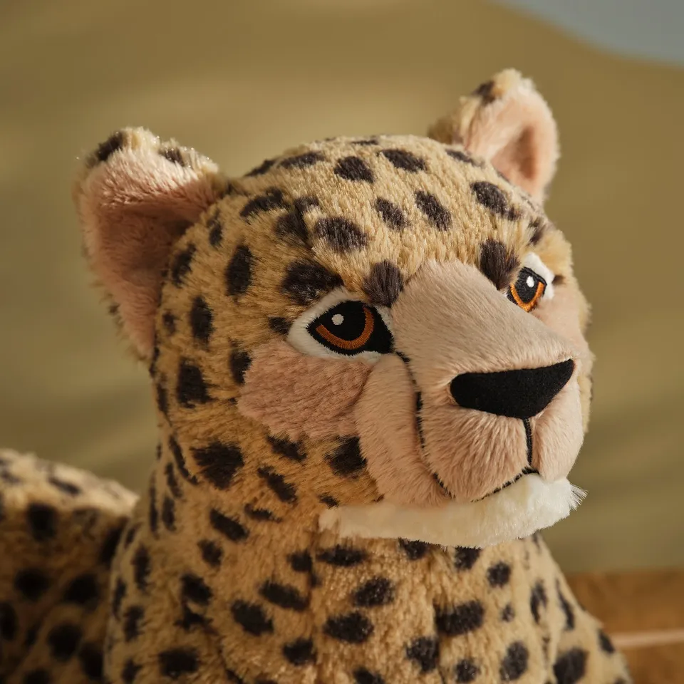 Stuffed cheetah toy with detailed face, soft fur, and friendly expression.