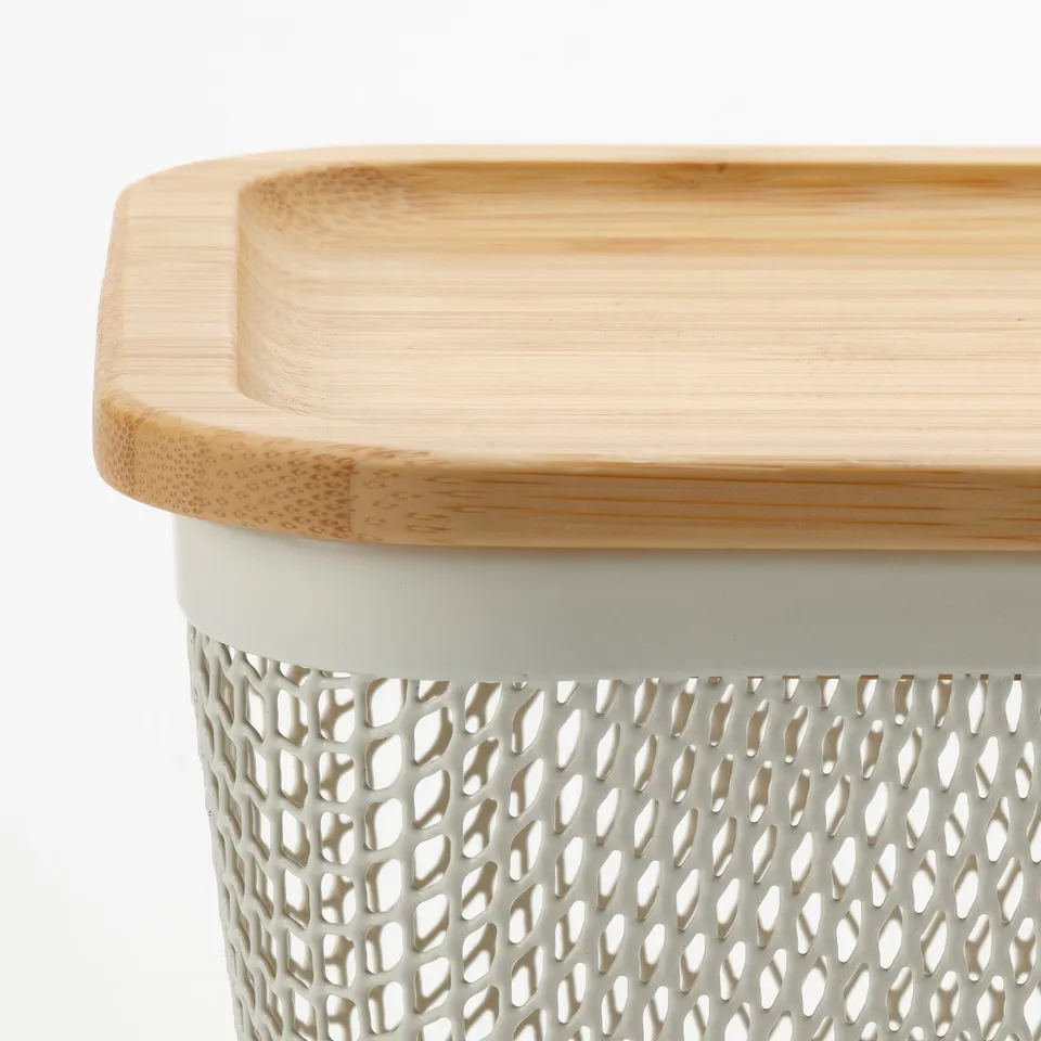 Modern bamboo-topped storage basket with perforated white steel base, ideal for fruits and vegetables.