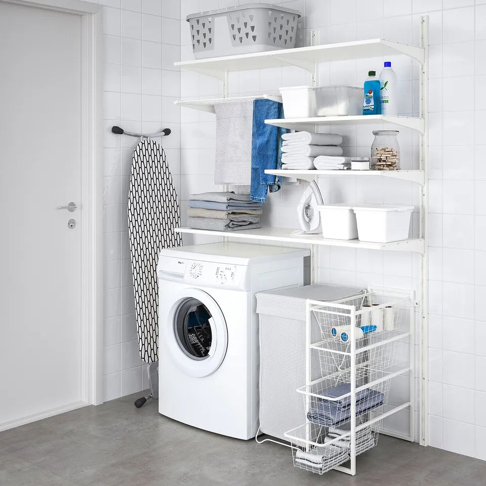 Laundry room with JONAXEL storage: towels, supplies, ironing board.