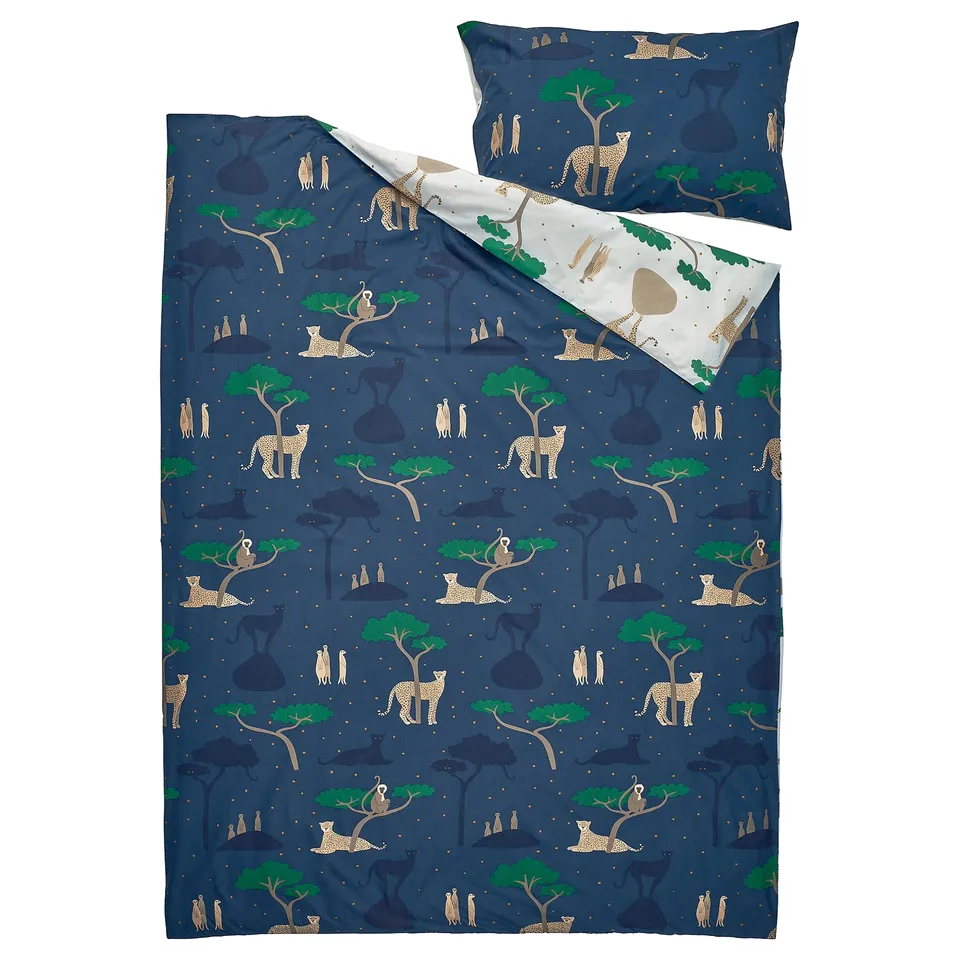 A blue SANDLÖPARE duvet cover set with cheetahs and trees in a savannah design, made from a blend of cotton and viscose.