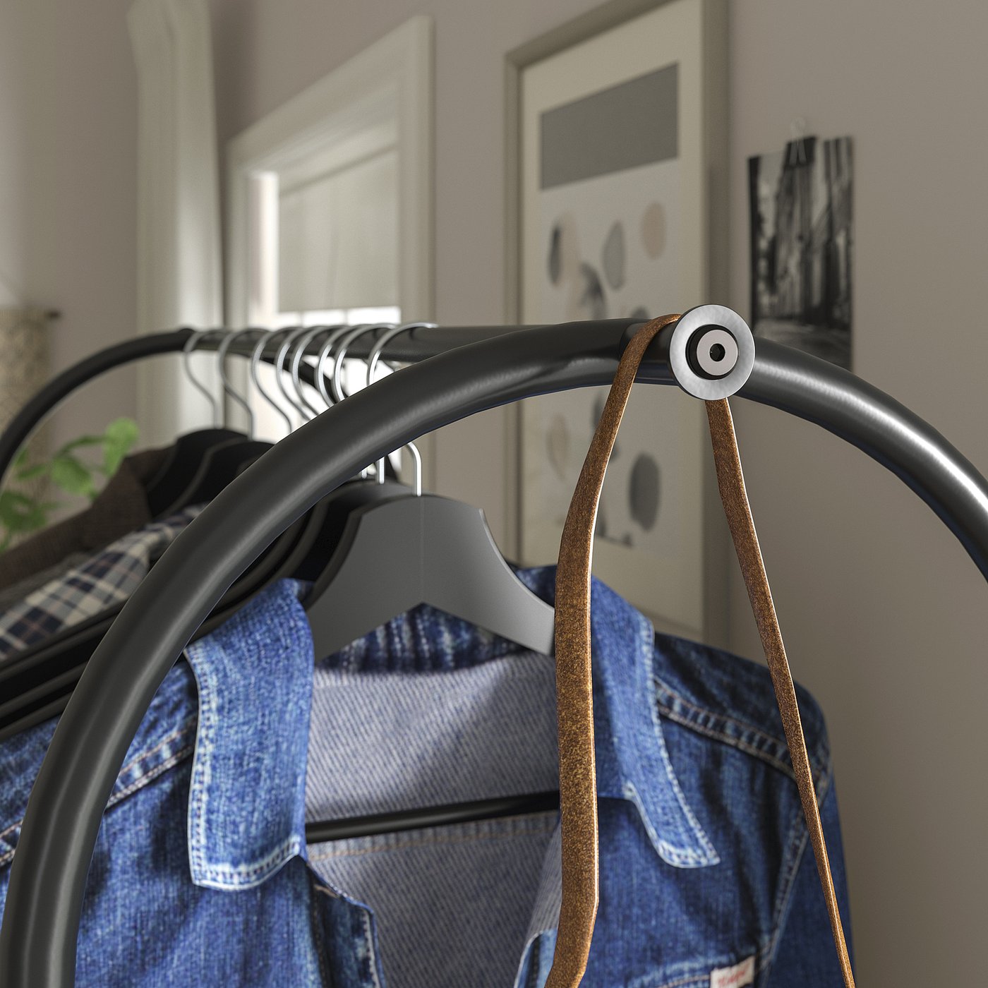 Clothes rack displaying jeans; both ends are hooks, perfect for hanging longer garments. Industrial-style design with metal joints and clean lines.