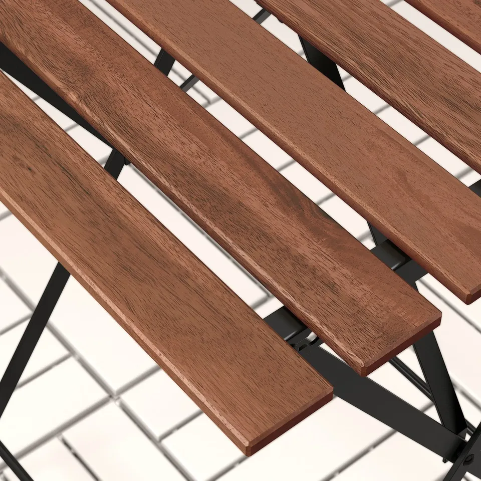 Wooden slats on a foldable outdoor table, showing rich grain and sturdy construction.