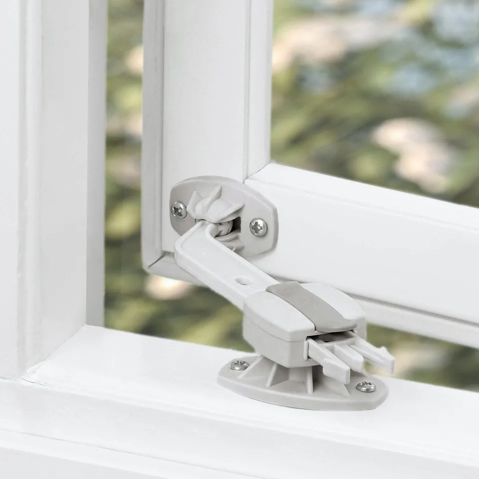 White window lock partially open, secured with two screws, designed to secure inward or outward opening windows.