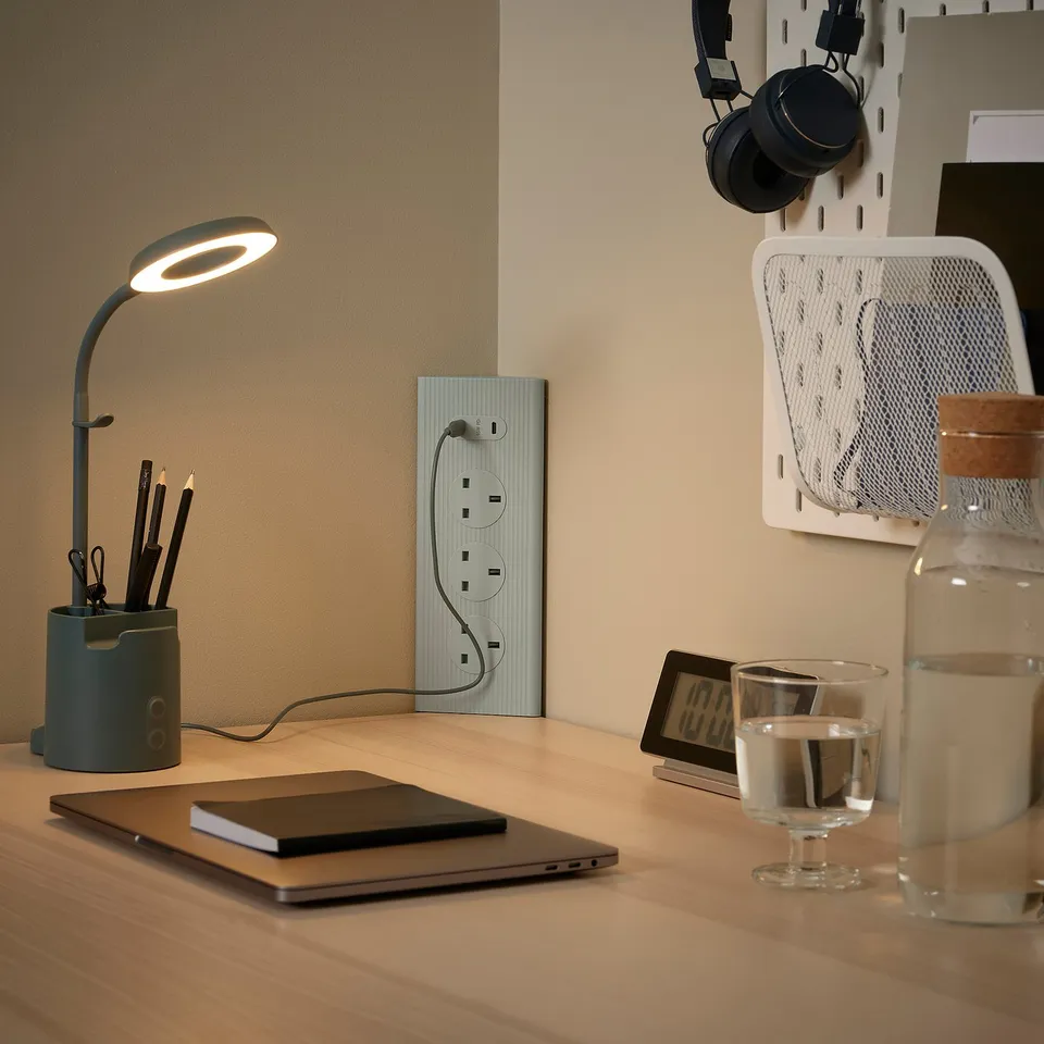 SKOTAT dark beige extension cord on desk, minimalist, eco-friendly recycled material.