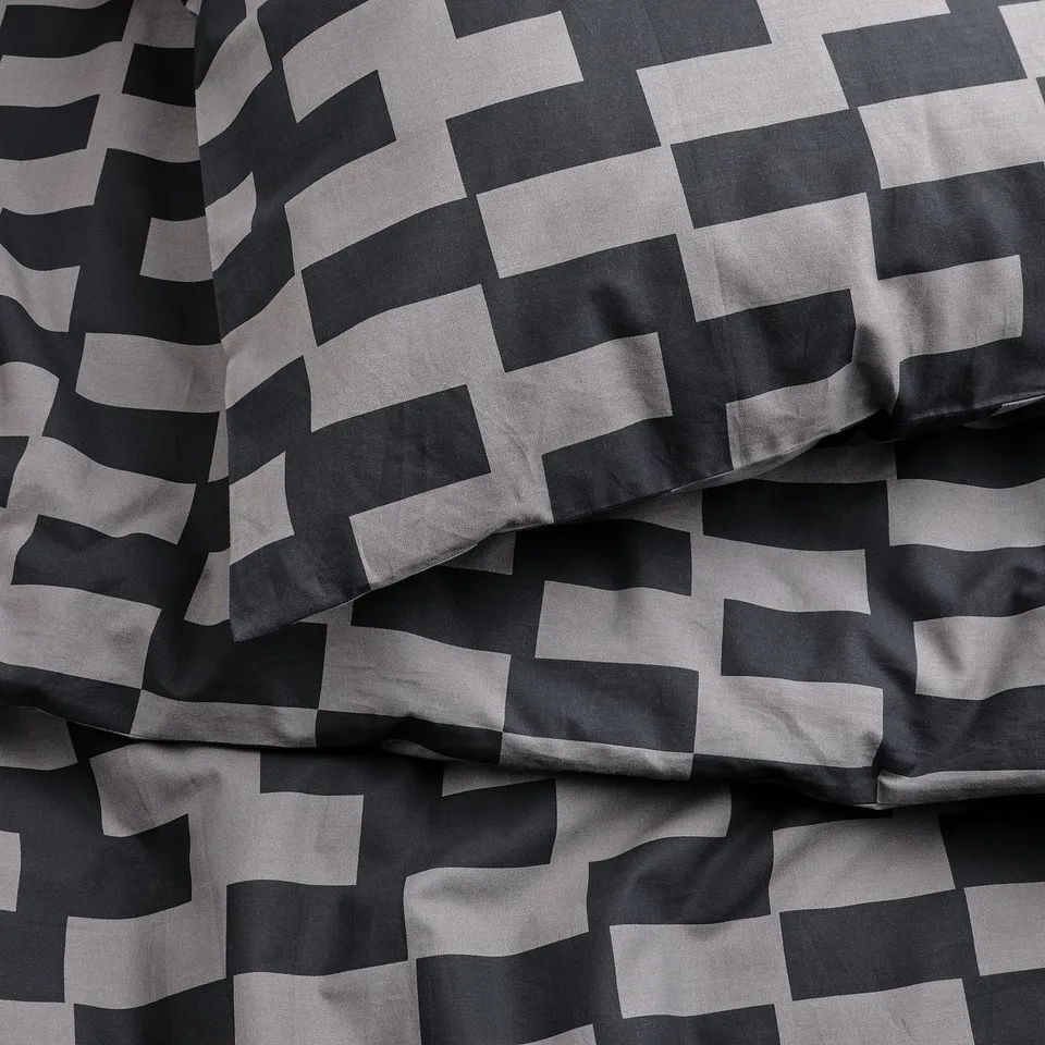 Black and white chequered duvet cover, neatly folded, showcasing soft fabric quality.