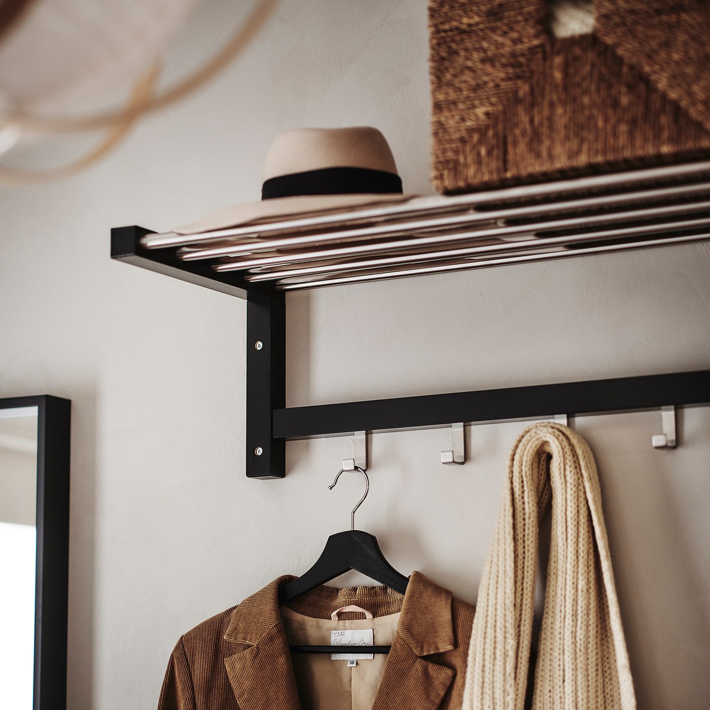 Wall-mounted coat rack with hat shelf. Holds jacket, hat, and knitted item. Minimalist design, solid wood.