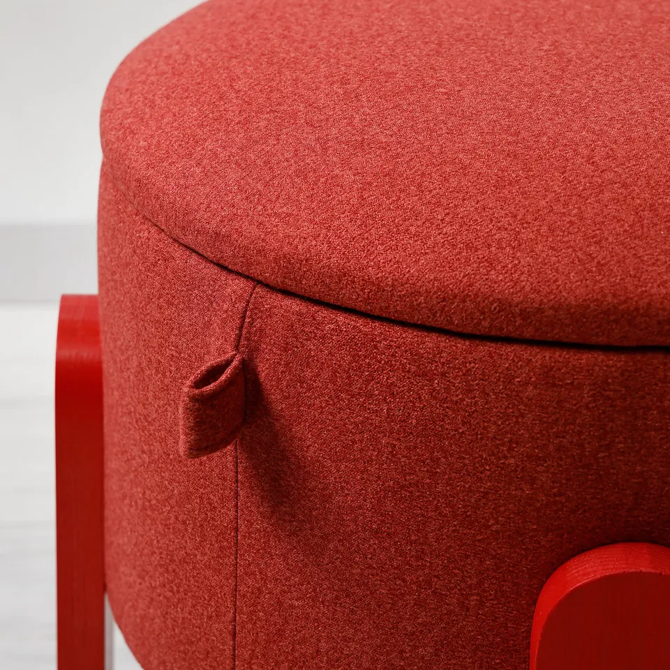 Close-up of FÖRLUNDA pouffes soft, red, recycled polyester cover with neat stitching and non-slip base.