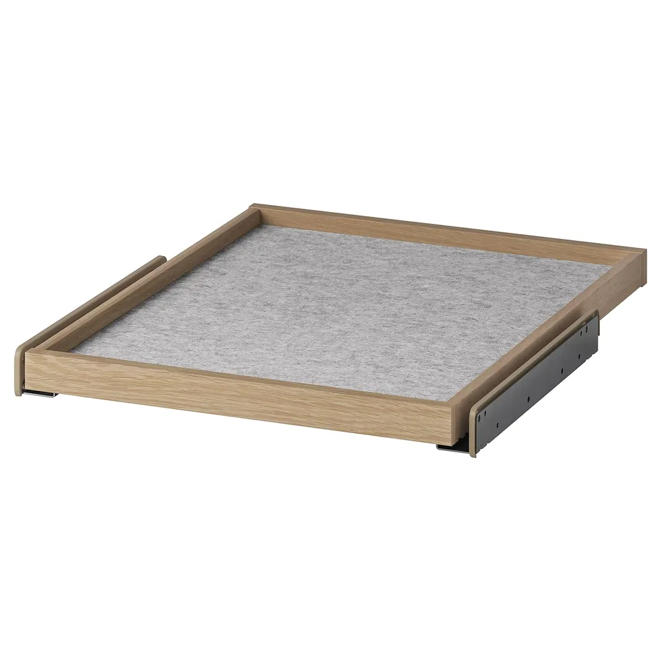 An oak-framed pull-out tray from IKEAs KOMPLEMENT series, featuring a light grey felt mat. It is designed for organising wardrobe space efficiently.
