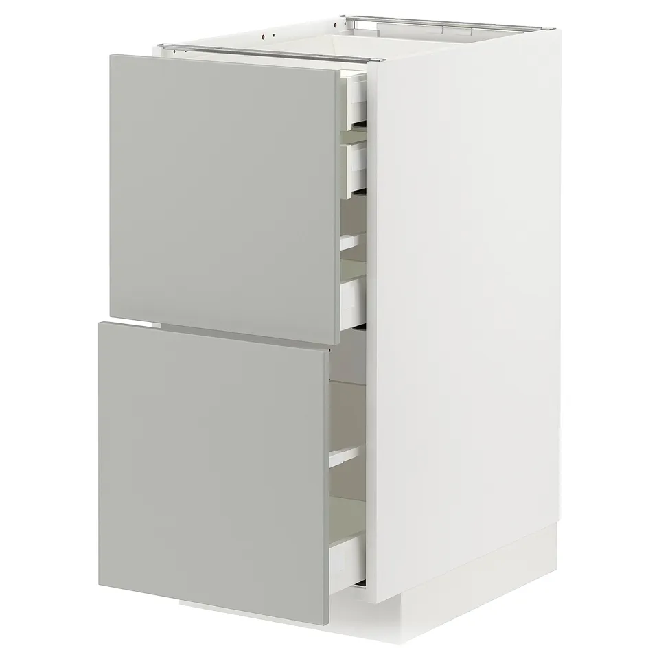 White ikea METOD kitchen cabinet with light grey drawers and doors.