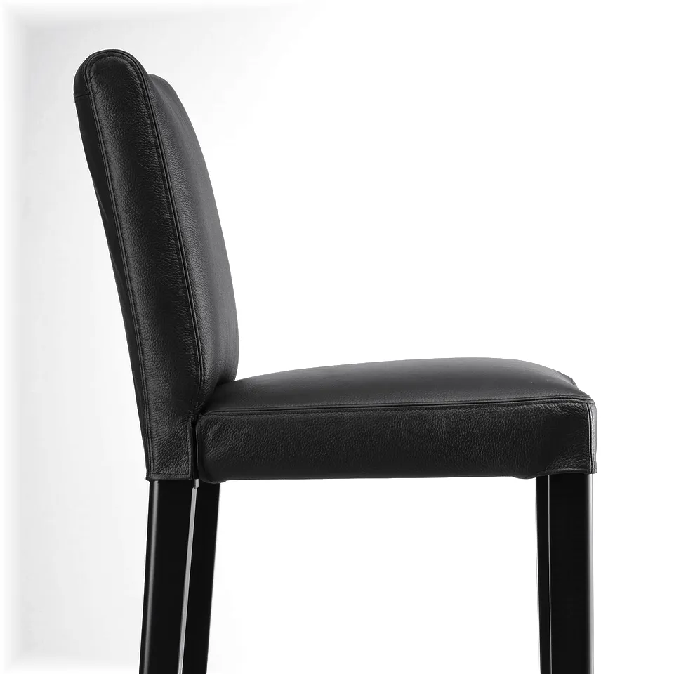 Black leather bar stool with metal legs, offering cushioned comfort and stylish design.