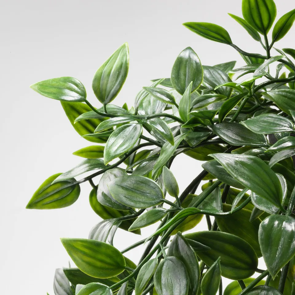 Lush artificial plant with vibrant, textured leaves, visually appealing and lifelike.