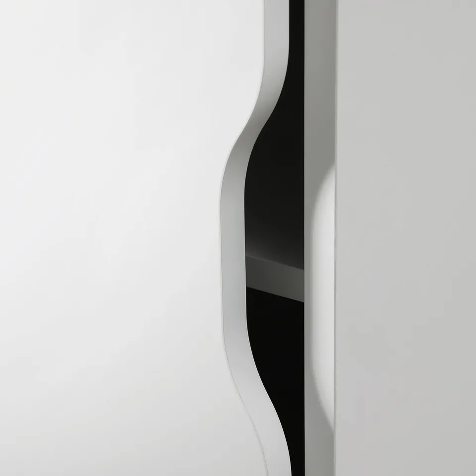 Modern, minimalist storage unit with curving door, smooth edges, and clean design.