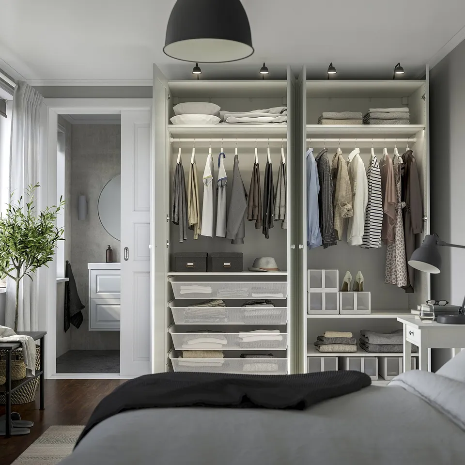 Bedroom with open wardrobe displaying clothes, storage boxes, and hanging space. Includes adjustable shelves and integrated lighting.