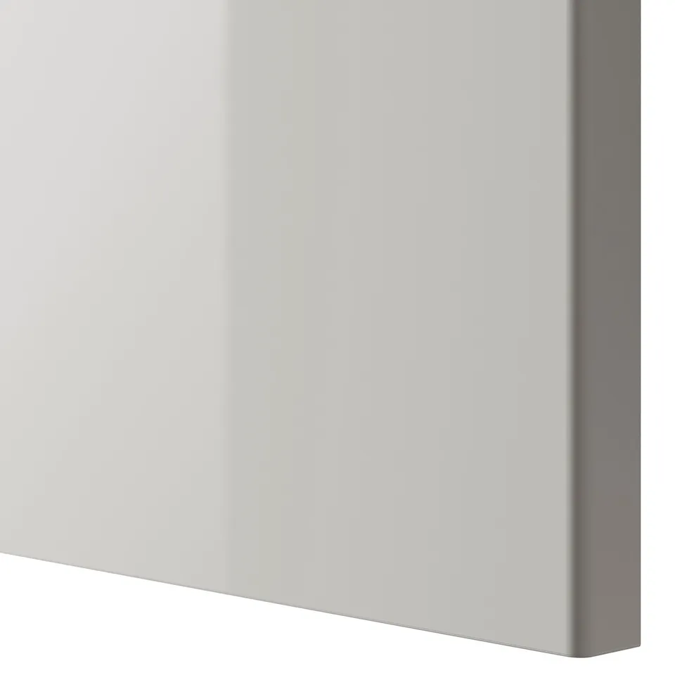 Close-up of modern, high-gloss white cabinet edge. Sleek design, smooth surface.