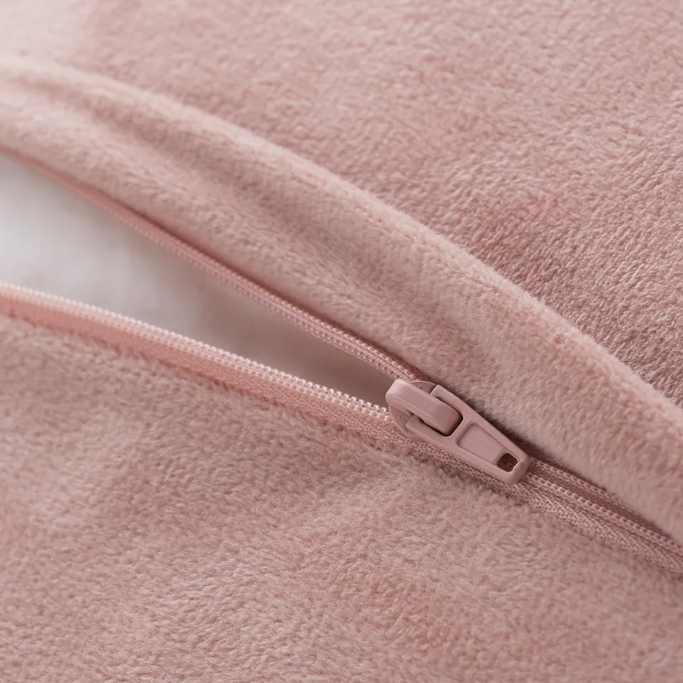 Pink cushion cover with zip, made from soft, recycled material.