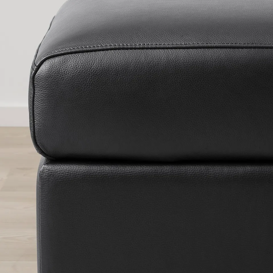 Close-up of VIMLE sofa in high-quality black leather, showcasing smooth, durable grain and clean stitching.