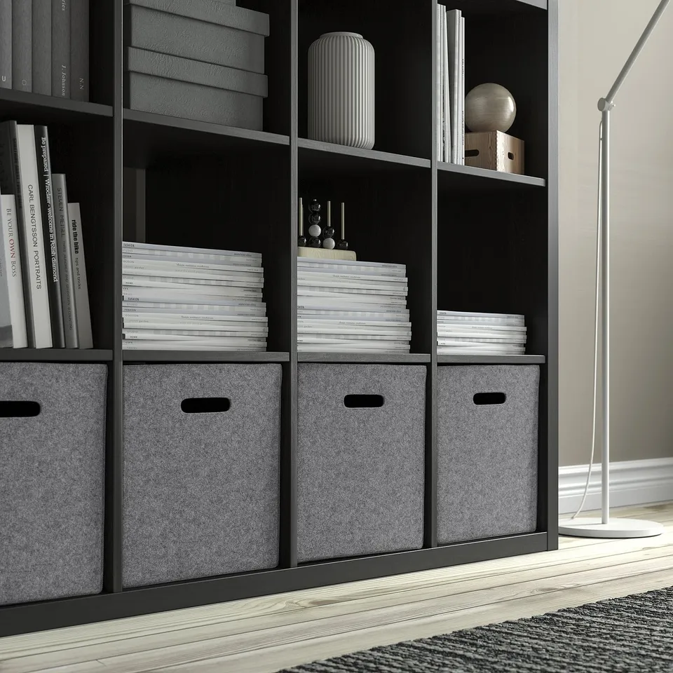 Black bookshelf with grey felt boxes and document stacks. Ideal for kallax shelving, offering organised storage in living spaces.