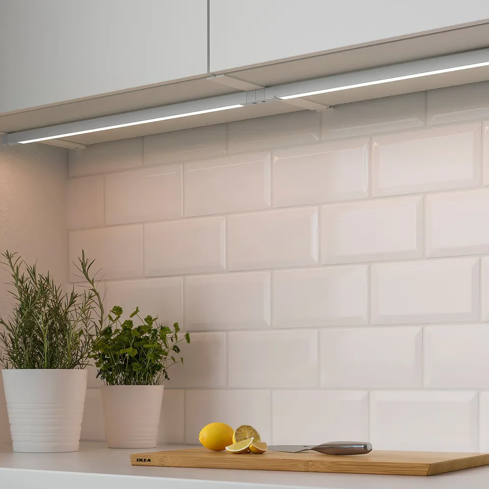Modern kitchen with herbs, lemon, cutting board, led lights.