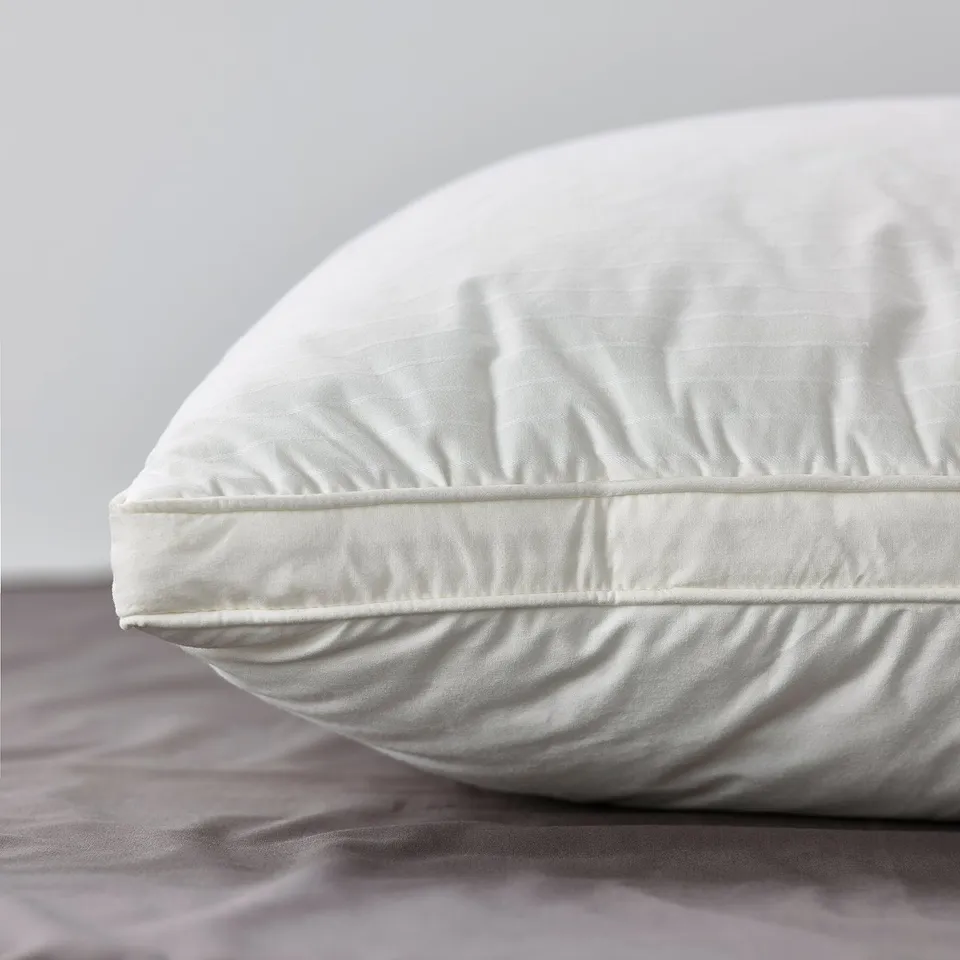 A luxurious pillow with dobby woven cotton fabric, featuring supportive core and plush outer filling, ideal for side or back sleepers.