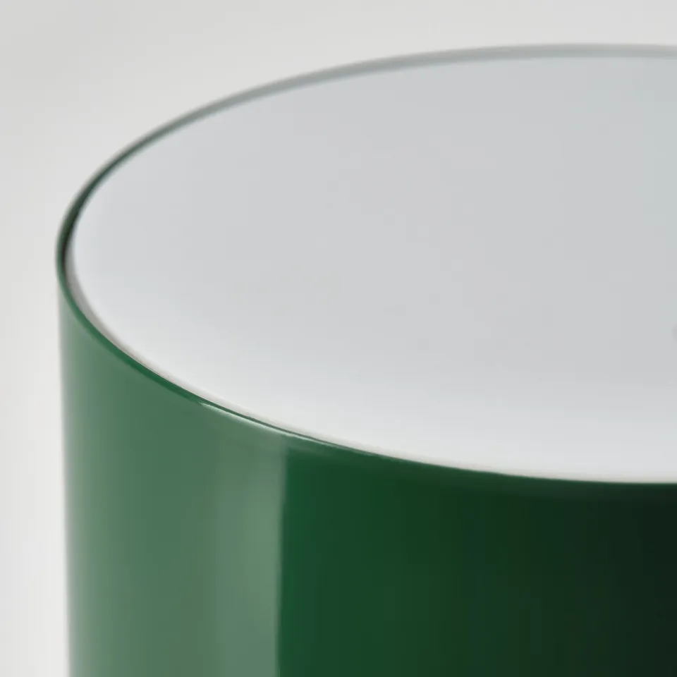 Modern table lamp with sleek green base and smooth white top, showcasing high-quality design.