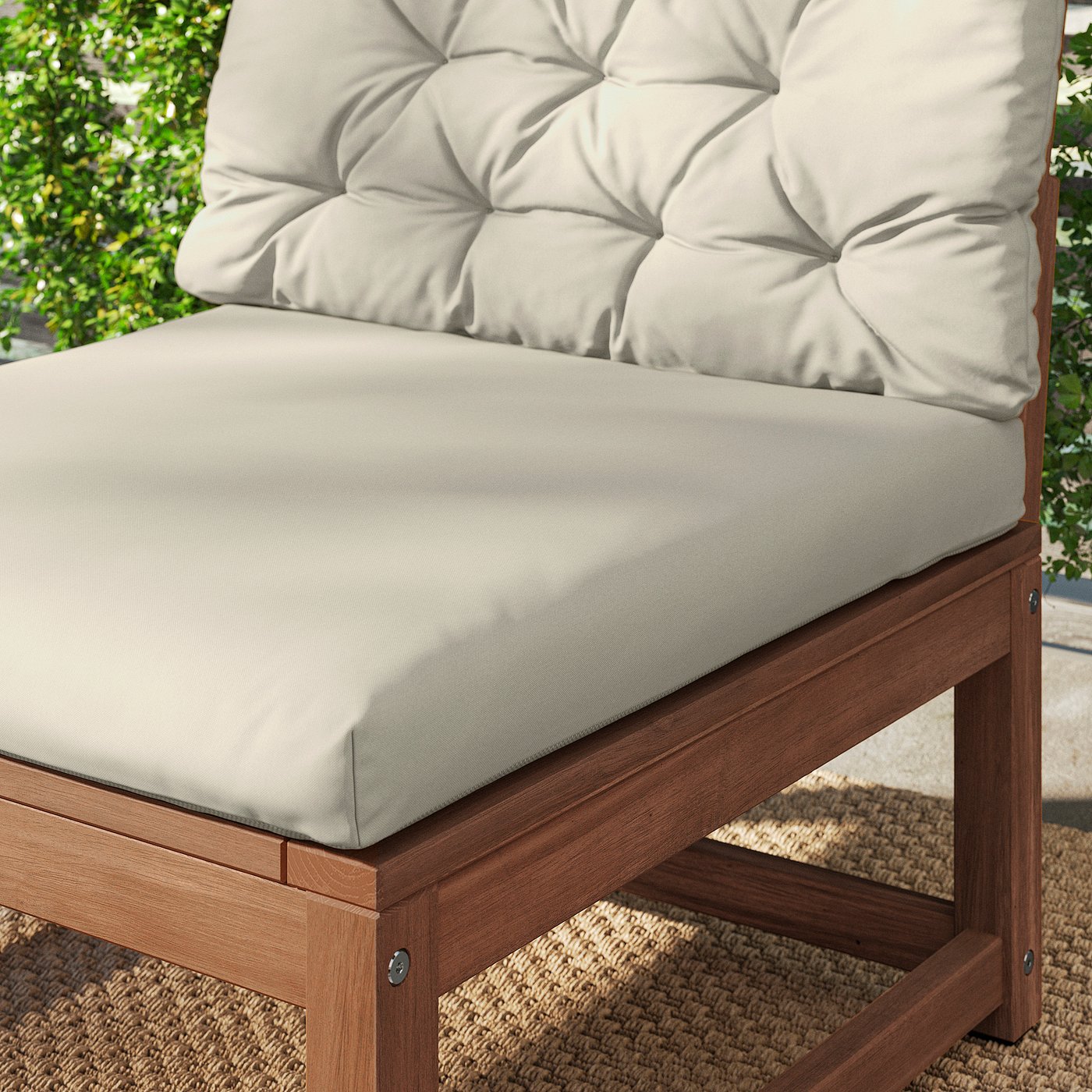 Comfortable outdoor chair with thick, beige cushions for relaxation. Crafted from durable hardwood for longevity.