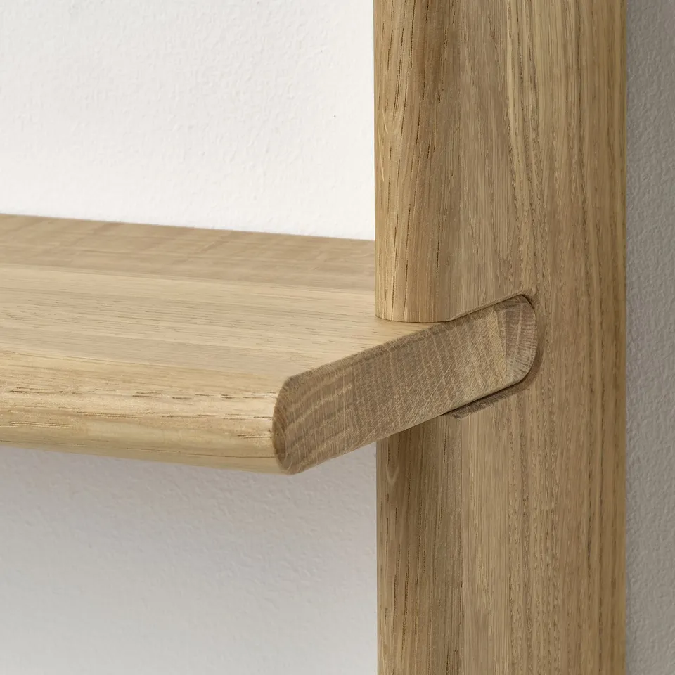 Oak wooden shelf with sleek design, natural finish, showing craftsmanship, mounted on wall.