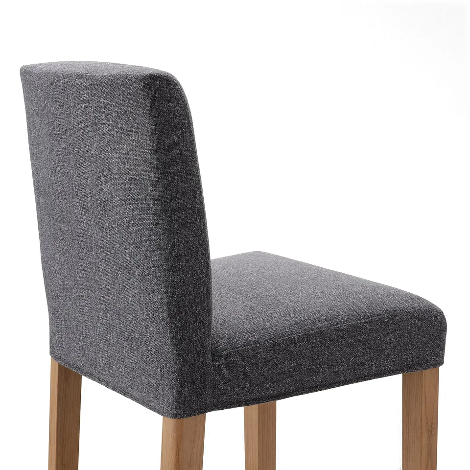 Grey upholstered bar stool with wooden legs, designed for comfort and style.