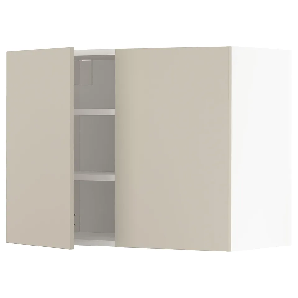 A beige METOD wall cabinet with one open door, revealing an adjustable shelf.