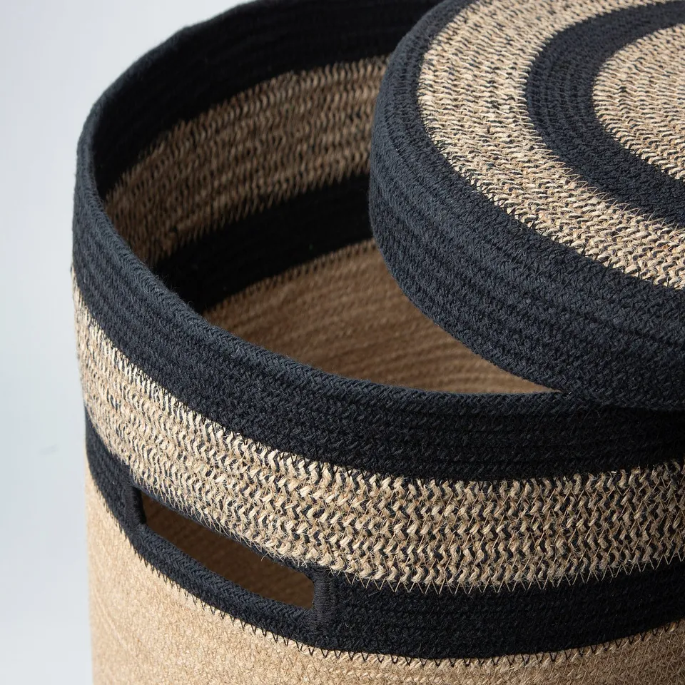 Large circular woven basket with black and natural jute, durable and stylish for storage.