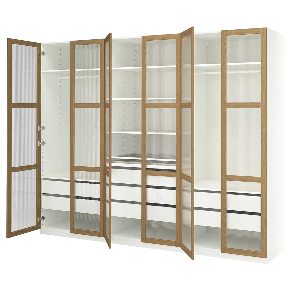 A white and wood-colored ikea PAX wardrobe with frosted glass doors, open to display shelves and compartments.
