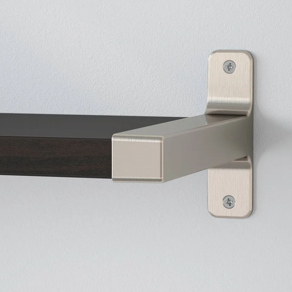 Close-up of modern metal bracket supporting wooden shelf. Nickel finish, securely mounted.