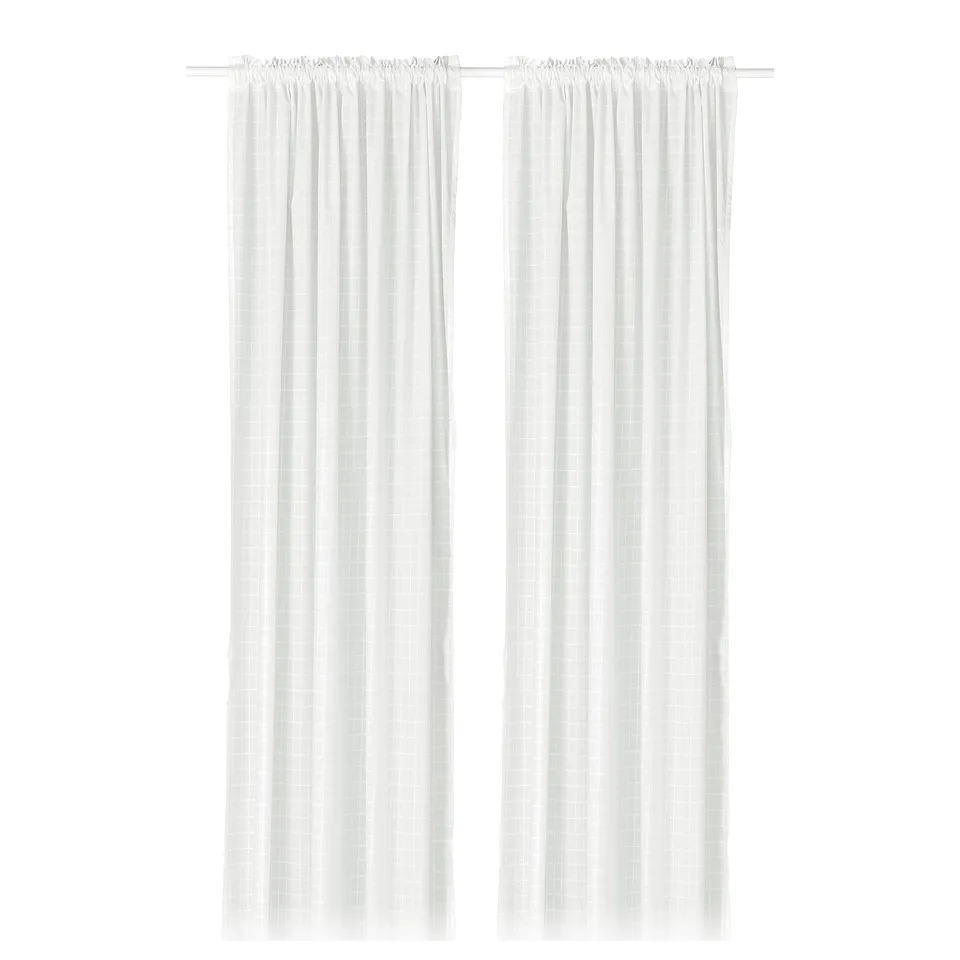 White grid-patterned curtains, eco-friendly from recycled polyester, provide privacy with soft daylight.