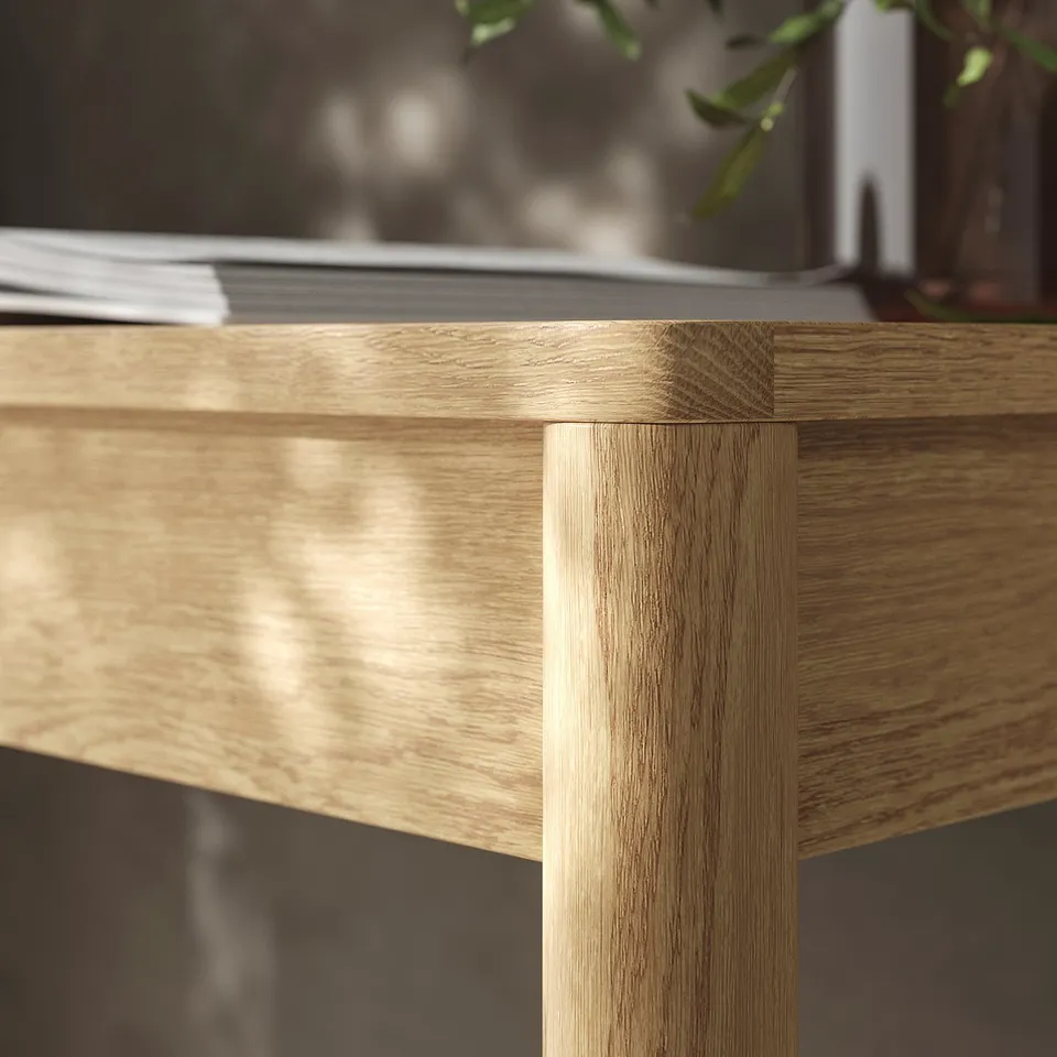 Light wooden desk shows durable, stain-resistant veneer with visible grain texture and clean lines, highlighting quality craftsmanship.