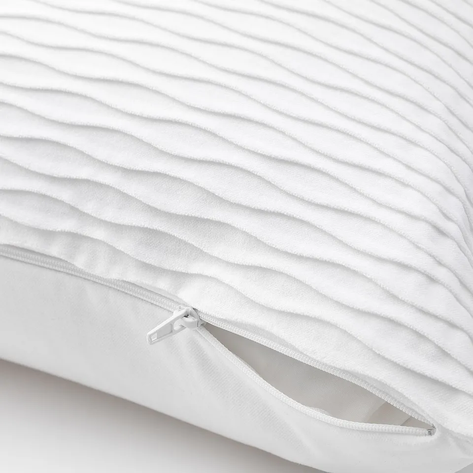 White quilted pillow with zip detail, showcasing its removable cover.