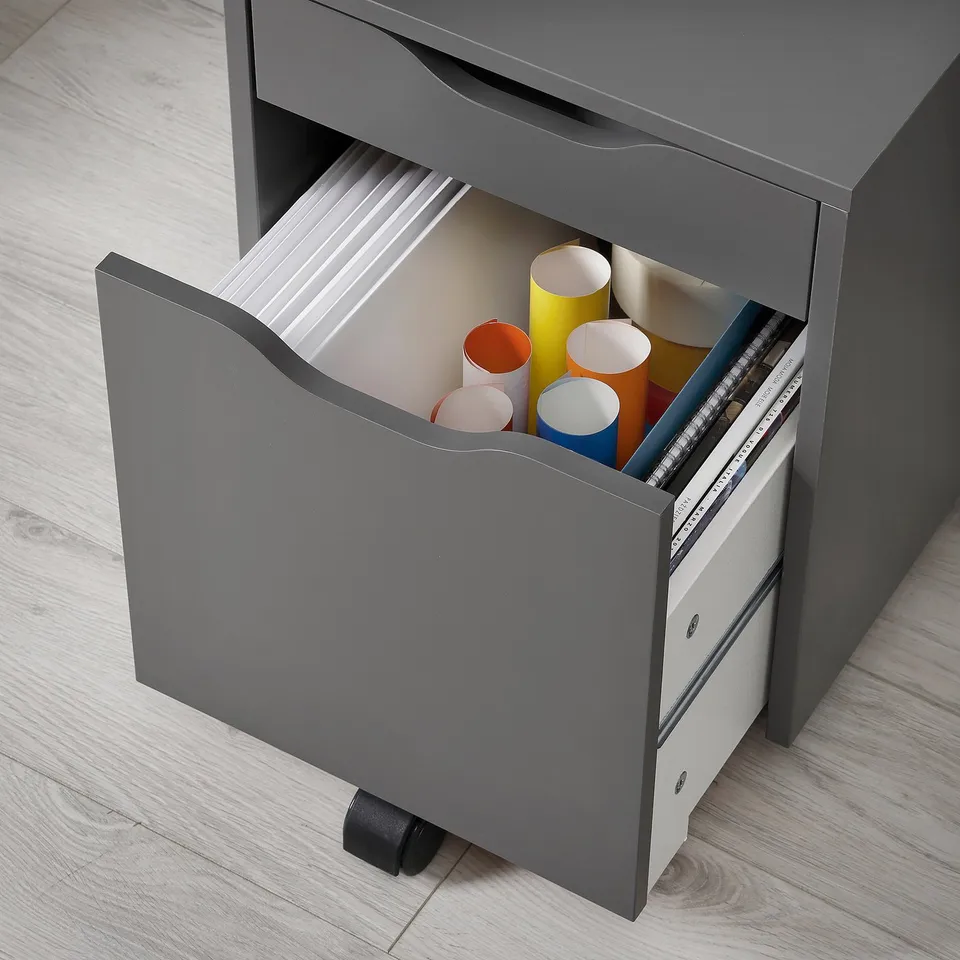 Grey ALEX drawer unit with wheels, holding coloured paper tubes and binders.