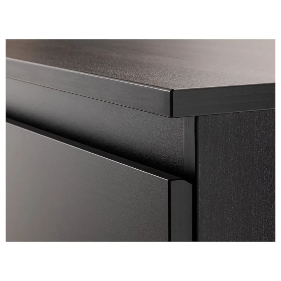 Close-up of modern dark furniture, showcasing sleek edges and quality finish.