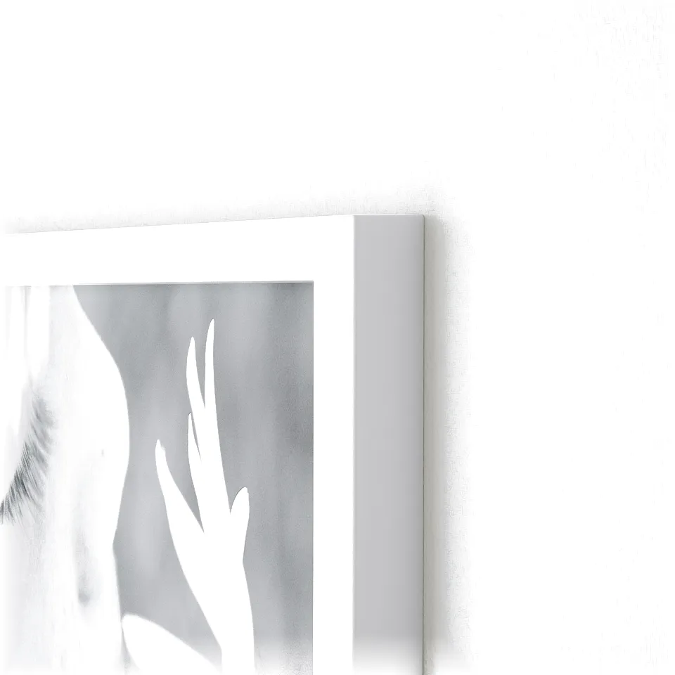 Modern white photo frame by vaxbo, mounted on a plain wall. Close-up frames sleek, smooth plastic design.