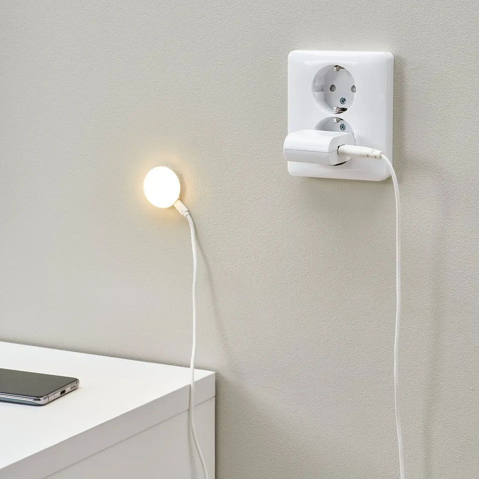 Usb spotlight in wall outlet, warm light on surface